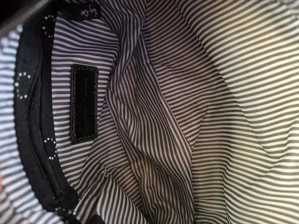 Thirty-One black hobo shoulder bag with white polka dot circles and striped inte